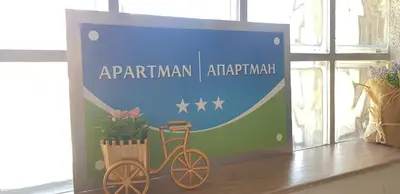 a sign for an apartmentarian apartment with a bike at Apartman M&B - Kuća za odmor-Karanovac in Topići