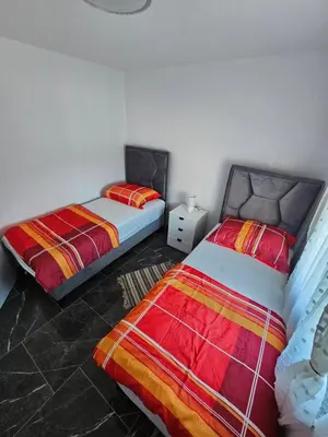 two beds sitting next to each other in a bedroom at Deluxe House Aqua Una in Otoka