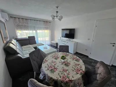 a living room with a table and a couch at Deluxe House Aqua Una in Otoka