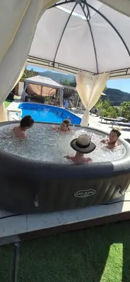 a group of people swimming in a hot tub at Ranc Cika Zlaje in Vitez