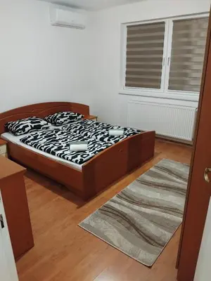 a bedroom with a bed and a window and a rug at Dinn in Jajce