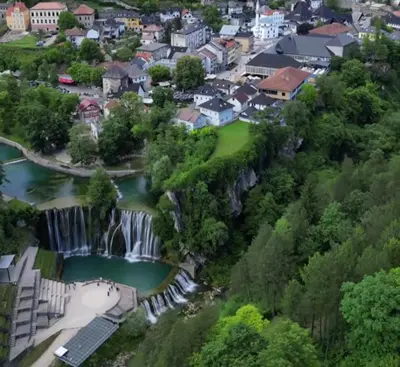 an aerial view of a town with a waterfall at Dinn in Jajce