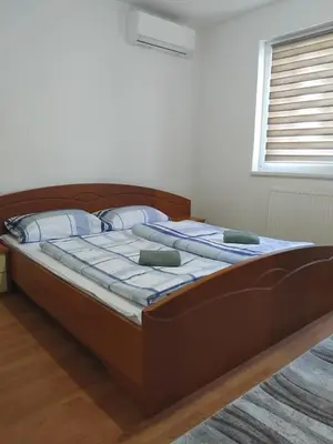 a large bed in a room with a window at Dinn in Jajce