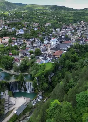 an aerial view of a town with a waterfall at Dinn in Jajce