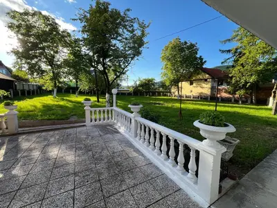 a white fence with potted plants on top of a yard at Home Nur in Ivišovo Greblje