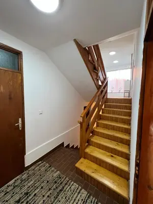 a stairwell in a house with a wooden staircase at Home Nur in Ivišovo Greblje