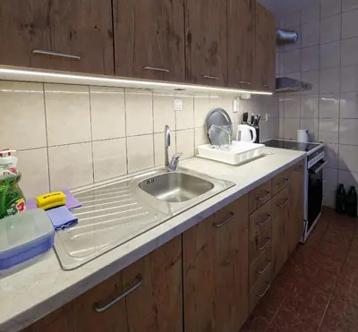 a kitchen with a sink and a counter top at MI apartman in Tuzla