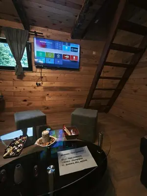 a room with a table and two chairs and a tv at Janjske Otoke Brvnara Tiho Ognjiste in Šipovo