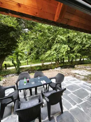 a picnic table and chairs on a patio at Janjske Otoke Brvnara Tiho Ognjiste in Šipovo