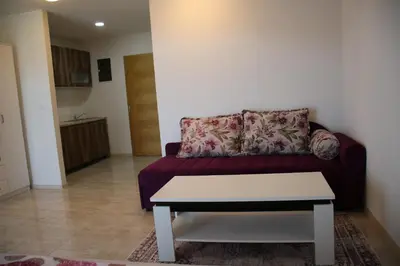 a living room with a couch and a table at Villa Leamax - Stan 9 in Velika Kladuša