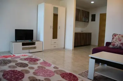 a living room with a couch and a tv at Villa Leamax - Stan 9 in Velika Kladuša