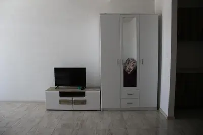 a living room with a tv on a cabinet at Villa Leamax - Stan 9 in Velika Kladuša
