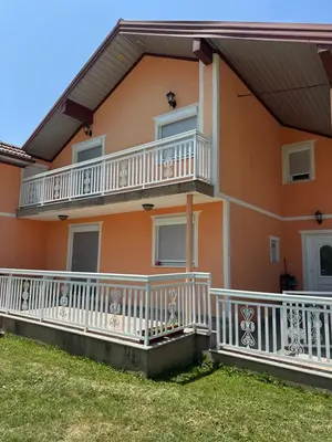 a house with white rails and balconies at Apartman Lida in Izačić