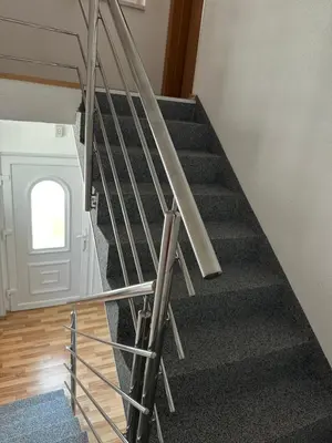 a staircase in a house with a metal railing at Apartman Lida in Izačić