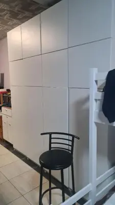 a black chair sitting next to a white refrigerator at Durmeo in Ripač