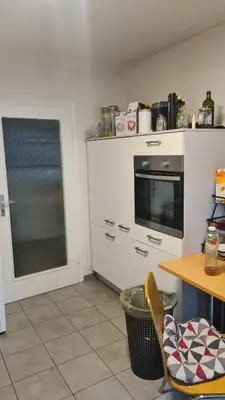a kitchen with a table and a stove and a table and a table at Durmeo in Ripač