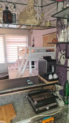 a room with a table with a printer and a bed at Durmeo in Ripač