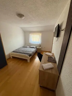 a small room with a bed and a table at Motel Napoleon in Velika Kladuša