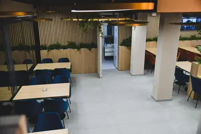 a meeting room with tables and chairs in a building at Motel Napoleon in Velika Kladuša