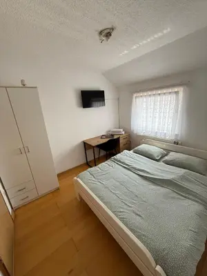 a bedroom with a bed and a desk in it at Motel Napoleon in Velika Kladuša