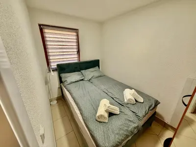 a bedroom with a bed with two slippers on it at Endzi V&S in Šišava