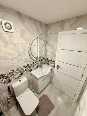 a bathroom with a toilet and a sink and a mirror at Endzi V&S in Šišava