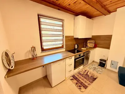 a kitchen with a counter and a window in it at Endzi V&S in Šišava