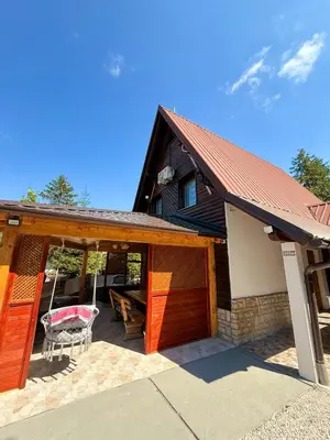 a house with a garage and a table at Endzi V&S in Šišava