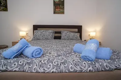 a bedroom with a bed with blue towels on it at Natural paradise Sake in Visoko