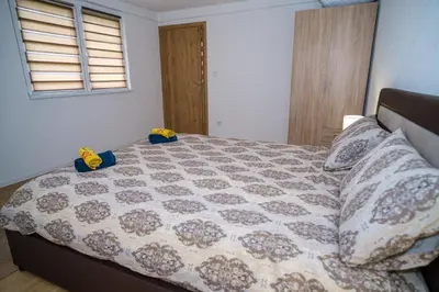 a bedroom with a bed with yellow shoes on it at Natural paradise Sake in Visoko