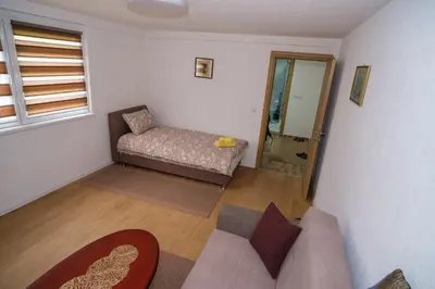 a living room with a couch and a mirror at Natural paradise Sake in Visoko