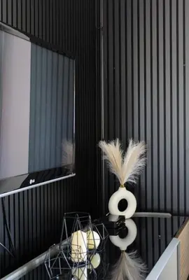 a room with a table with a mirror and a vase with feathers at Wildlight in Bihać