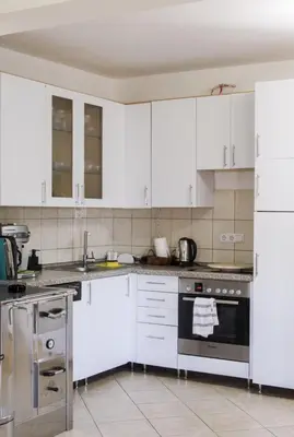 a kitchen with white cabinets and a stove top oven at Wildlight in Bihać
