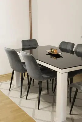 a dining room table with gray chairs and a black table at Wildlight in Bihać