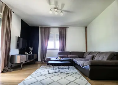 a living room with a couch and a table at Wildlight in Bihać