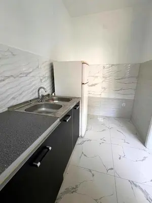 a small kitchen with a sink and a tiled floor at Guest House 369 in Jajce