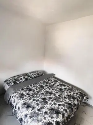 a bedroom with a bed with a black and white comforter at Guest House 369 in Jajce