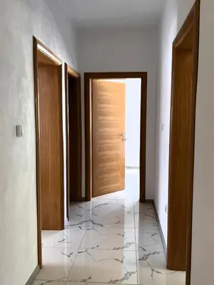an empty hallway with a door and a tile floor at Guest House 369 in Jajce