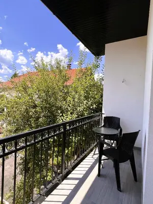 a black table and chair on a balcony at Guest House 369 in Jajce
