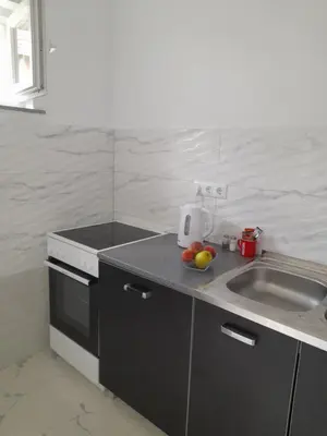 a kitchen with a sink and a counter top at Apartman 369 in Jajce