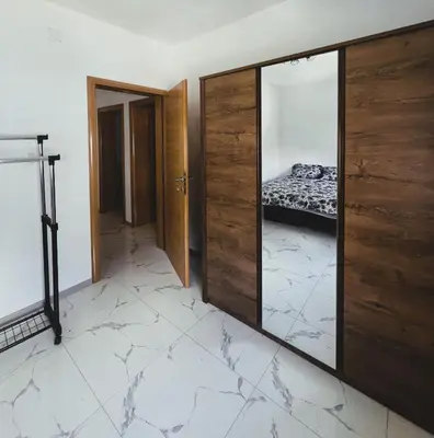a room with a mirror and a bed in it at Apartman 369 in Jajce