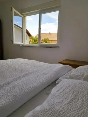 a bedroom with a window with a view of the beach at Apartman 369 in Jajce