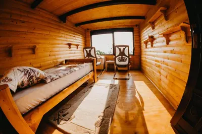 a room with two beds in a wooden cabin at Djedovo Ognjiste,prenociste in Modriča