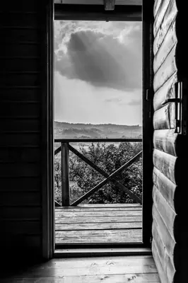 an open door to a balcony with a view of the ocean at Djedovo Ognjiste,prenociste in Modriča