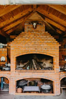 a brick oven with pots and pans in it at Djedovo Ognjiste,prenociste in Modriča