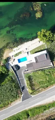 an aerial view of a house next to the water at Apartmani na Uni Šarac