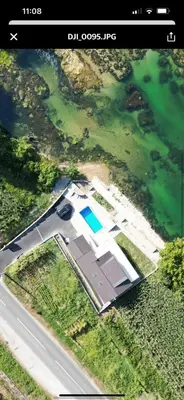 an aerial view of a house next to the water at Apartmani na Uni Šarac