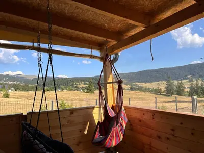 two hammocks hanging from a porch with a view at Vikendica Nuhanović - Vlašić in Vlasic