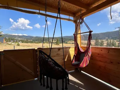 two hammocks hanging on the porch of a cabin at Vikendica Nuhanović - Vlašić in Vlasic