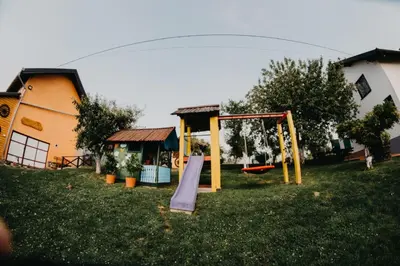 a playground with a slide in a yard at Djedovo ognjište 2